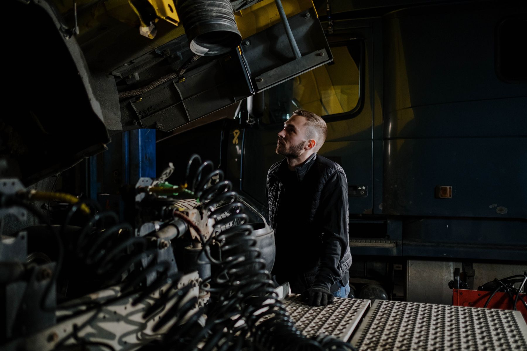 Diesel technician inspecting a heavy truck engine