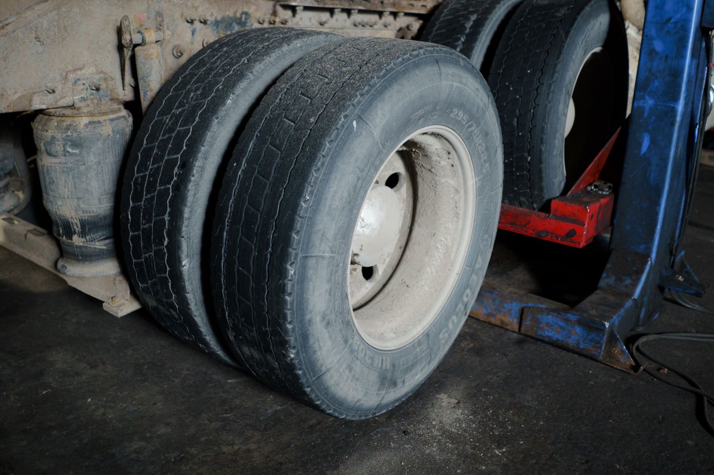 Close view of heavy truck tires and suspension during maintenance